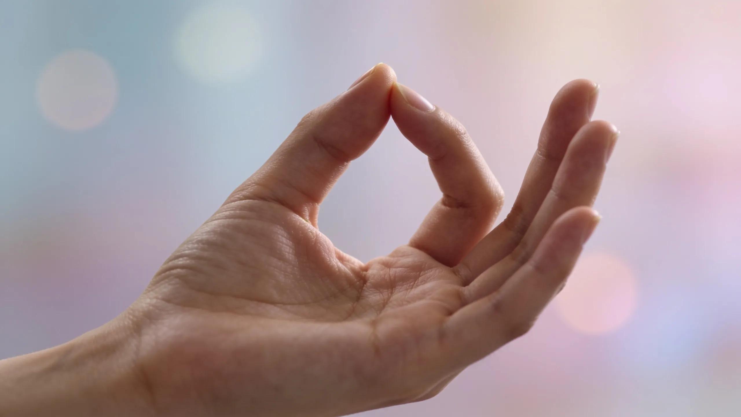 Close-up of hands performing the anchoring technique for anxiety relief